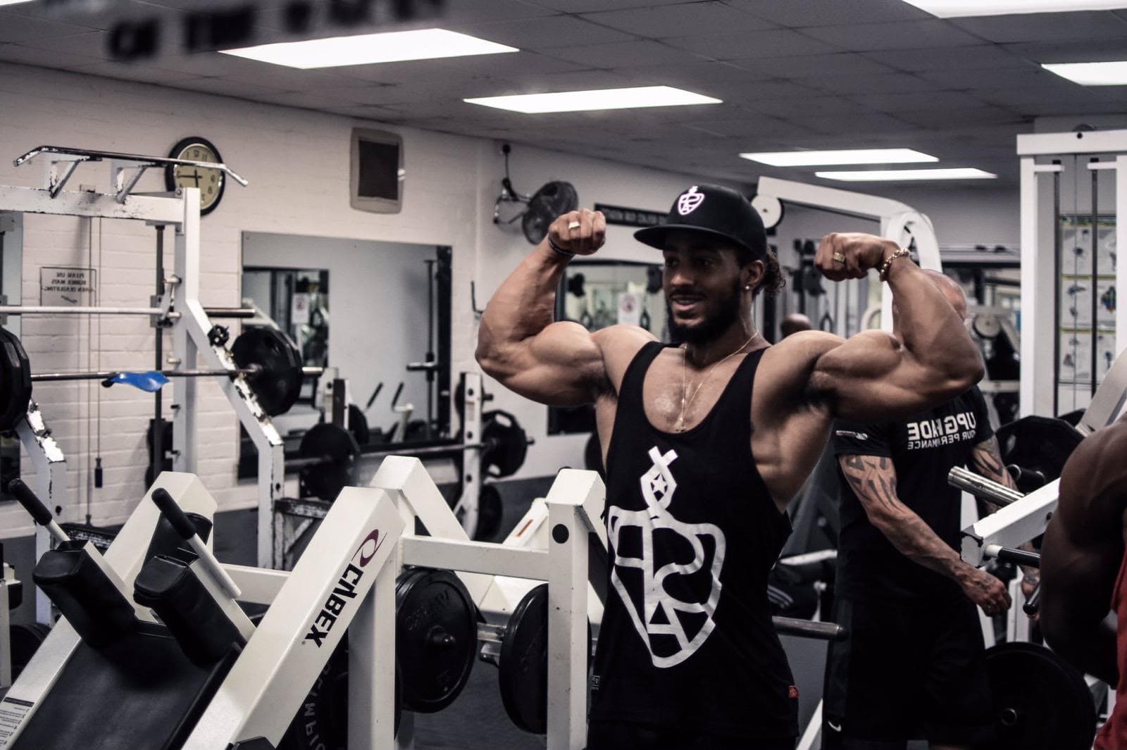 Antonio front double biceps on the gym floor